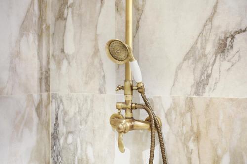 une douche avec pommeau de douche dans une salle de bain dans l'établissement Residence in the center of Paris by Studio prestige, à Paris