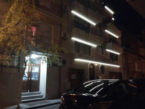 a car parked in front of a building at night at Venis House in Plovdiv