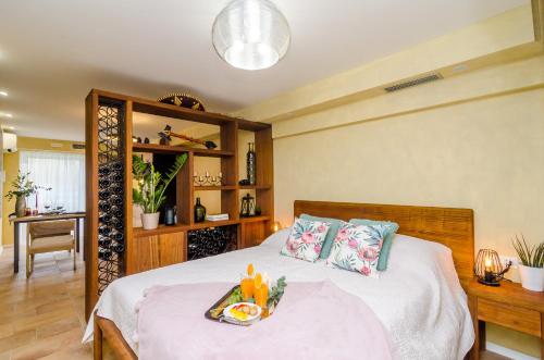 a bedroom with a bed with a tray of food on it at Apartment City Getaway in Dubrovnik