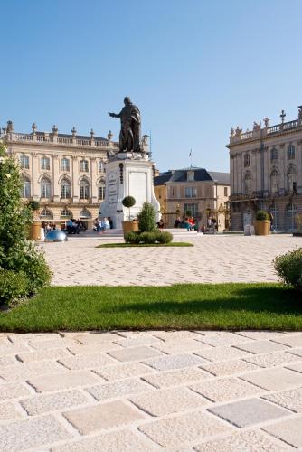 a statue in a courtyard in front of a building at Mercure Nancy Centre Place Stanislas in Nancy