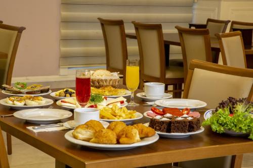 a table topped with plates of food and drinks at Bursa Palas Hotel in Bursa