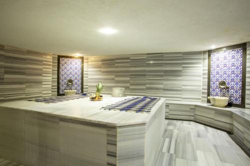 a spa room with a large bed and two windows at Bursa Palas Hotel in Bursa