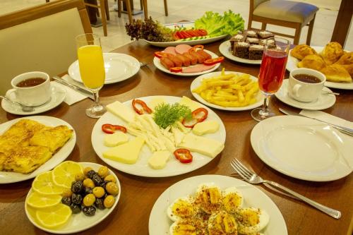 a table full of plates of food and drinks at Bursa Palas Hotel in Bursa