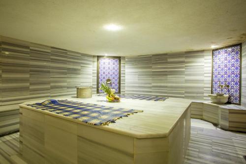 a spa room with a bed and two windows at Bursa Palas Hotel in Bursa
