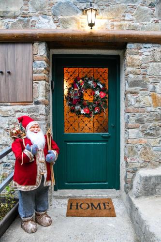 a santa claus statue standing in front of a door at Sophias Cottage in Askas