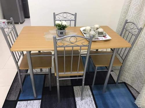 a dining room table and chairs with a wooden table and a table and chairsktop at Homestay AlFaruqi Gambang (2) in Gambang