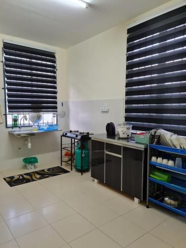 a kitchen with black blinds on the windows at Homestay AlFaruqi Gambang (2) in Gambang
