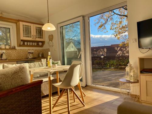 a kitchen and dining room with a table and a large window at Vila EVIO Třeboň in Třeboň