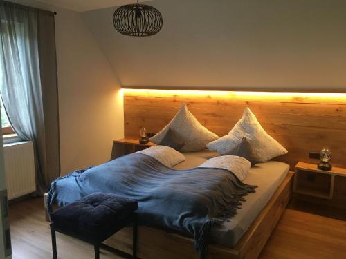 a bedroom with a large bed with a wooden headboard at s´Raubers in Bühlertal