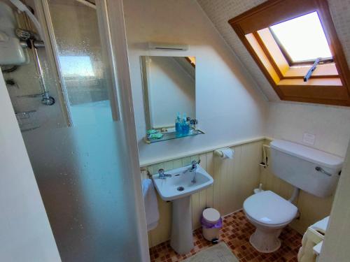 a bathroom with a sink and a toilet and a mirror at Bluestones in Keswick