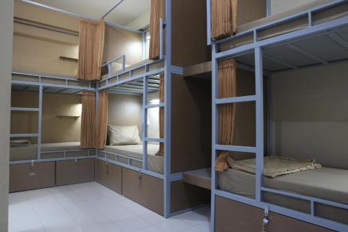 a room with four bunk beds in it at Aru House Ubud in Ubud