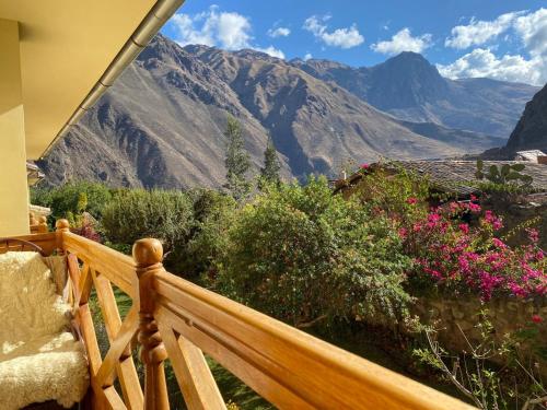 a wooden porch with a view of a mountain at Apu Lodge in Ollantaytambo