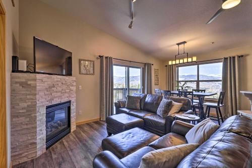 a living room with a couch and a fireplace at Newly Remodeled Mtn-View Condo in Silverthorne in Silverthorne