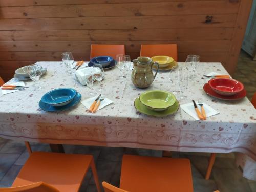 a table with plates and utensils on it at CHALET IL GELSOMINO DELL'ETNA in Giarre