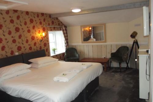 a bedroom with a large bed in a room at The Liverpool Arms Hotel in Beaumaris