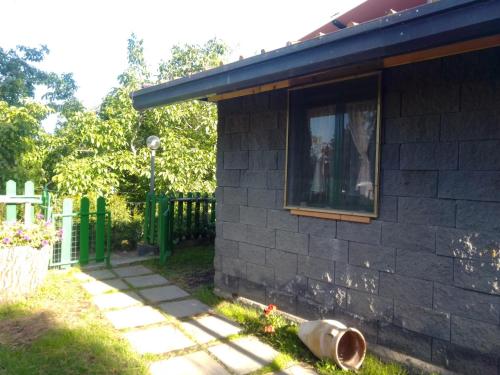 a house with a window on the side of it at CHALET IL GELSOMINO DELL'ETNA in Giarre