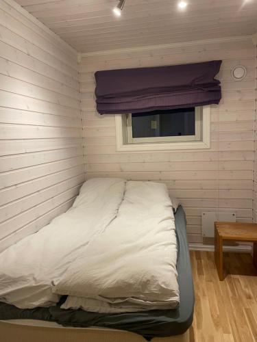 a bed in a room with a window at Spacious 50 sqm apartment close to city centre! in Tromsø