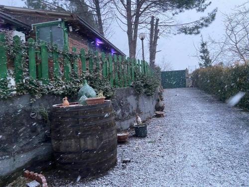 a house with a fence and some plants at CHALET IL GELSOMINO DELL'ETNA in Giarre