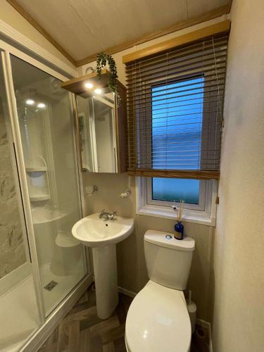 a small bathroom with a toilet and a sink at Lakeview Winter Lodge with Hot Tub in York