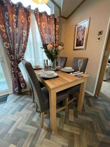 a dining room with a wooden table and chairs at Lakeview Winter Lodge with Hot Tub in York
