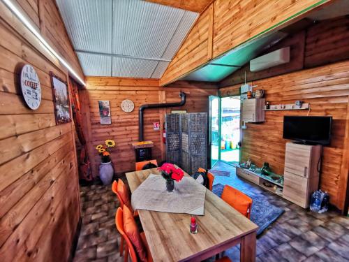 a dining room with a table and orange chairs at CHALET IL GELSOMINO DELL'ETNA in Giarre