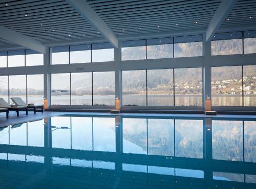 a swimming pool with a view of the mountains at ROBINSON Landskron in Landskron