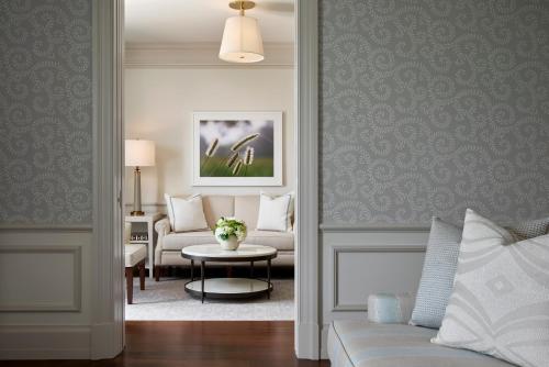 a living room with a couch and a table at Keswick Hall in Charlottesville