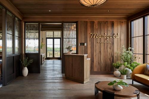 a lobby with a waiting area with a table and windows at Keswick Hall in Charlottesville