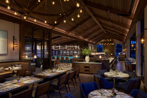 a restaurant with tables and chairs and lights at Keswick Hall in Charlottesville