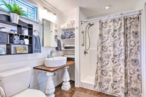 a bathroom with a sink and a shower at Historic Biloxi Bay Cottage with Beautiful View in Ocean Springs