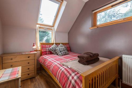 a small bedroom with a bed and a window at The Beeches Studio, Highlands of Scotland in Newtonmore