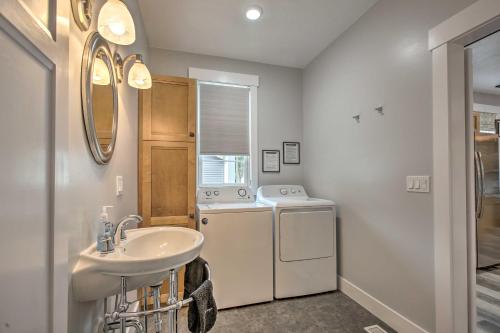 a bathroom with a sink and a washing machine at Bright Lower-Level Unit about 1 Mile to Lake Mich in Ludington