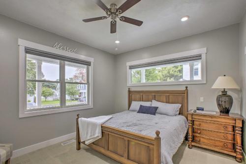 a bedroom with a bed and a ceiling fan at Bright Lower-Level Unit about 1 Mile to Lake Mich in Ludington