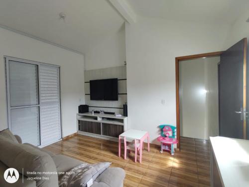 a living room with a couch and a table at Pousada Belas Praia Imbituba in Imbituba