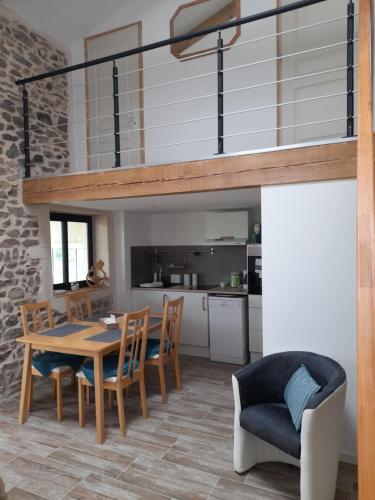 a kitchen and dining room with a table and chairs at Gîte Mascotte in La Gresle