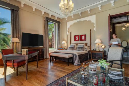 a large bedroom with a bed and a tv at The Oberoi Marrakech in Marrakesh