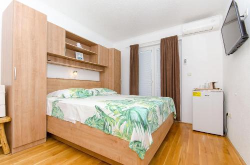 a bedroom with a bed and a television in it at House Nikola in Tučepi