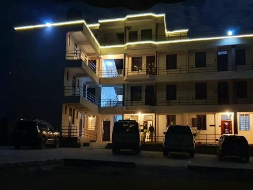 a building with cars parked in front of it at night at Walabi Mara Hotel in Narok