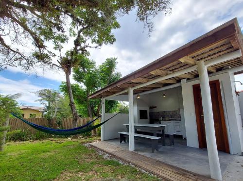 a patio with a hammock outside of a house at Refúgio 755 in Florianópolis