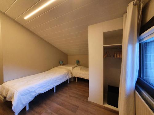 a bedroom with two beds and a window at Altissim Tarter - Inclès - Ransol in El Tarter