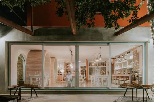 a store with glass doors and tables in a room at Luz Charming Houses in Fátima