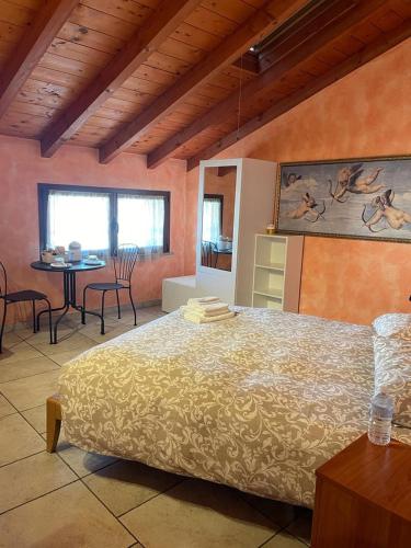 a bedroom with a bed and a table with chairs at Bed&Breakfast Milano Malpensa in Busto Arsizio