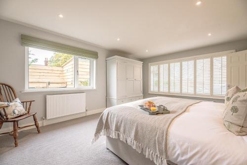 a bedroom with a large bed and a window at Festival House, Snape in Saxmundham