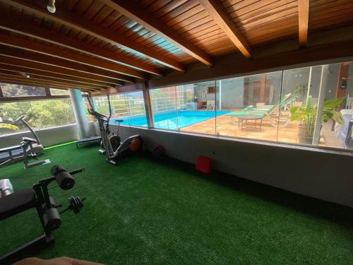 a house with a gym with a swimming pool at FIKA Residence in Dois Irmãos