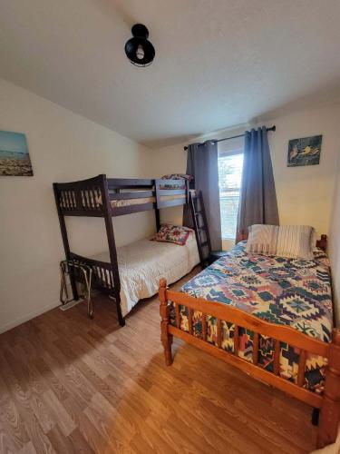 a bedroom with a bunk bed and a crib at Crater Lake Gateway-Rocky Point Resort in Klamath Falls