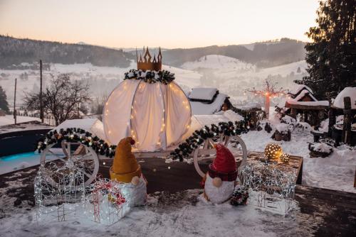 a carriage covered in christmas lights in the snow at Stara Pravda Hotel in Bukovel