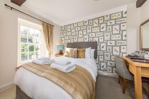 a bedroom with a bed with towels on it at The Red Lion in Northampton