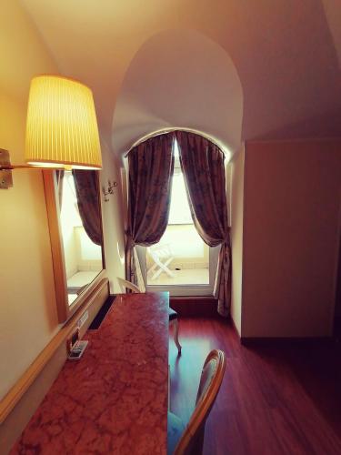 a living room with a table and a window at Ena Hotel in Arenzano
