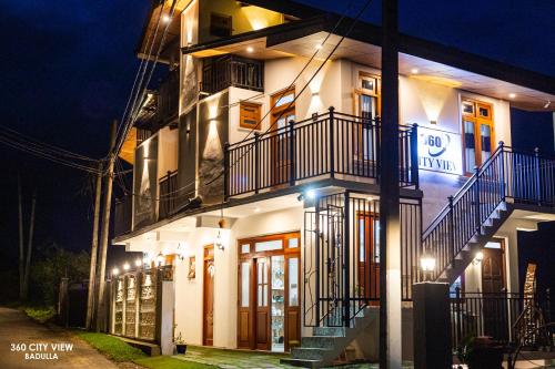a white building with stairs and lights on it at 360 City View in Badulla
