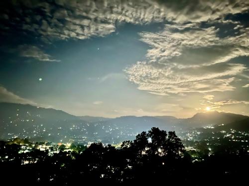 a view of a city from a hill with a cloudy sky at 360 City View in Badulla